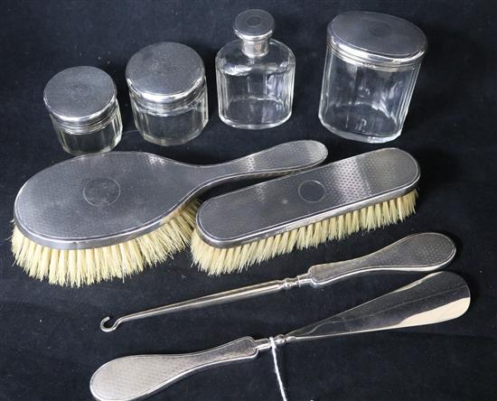 An eight-piece silver-mounted part dressing table set.